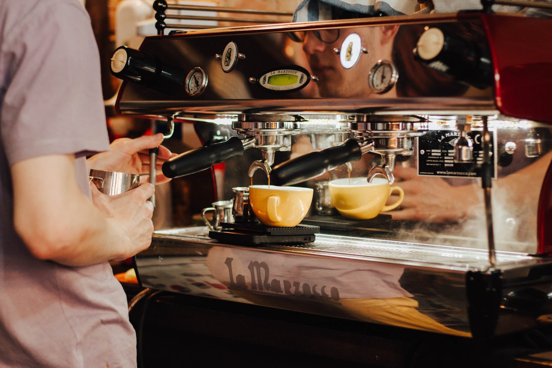 person using espresso machine